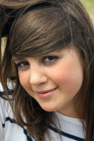 portrait of young beautiful teen on the meadow closeupの写真素材