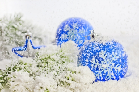 Christmas blue baubles and snowflakes on white background の写真素材