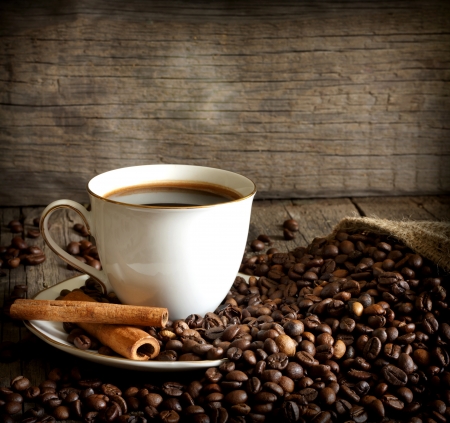Cup of coffee with beans and cinnamon vintage still lifeの写真素材