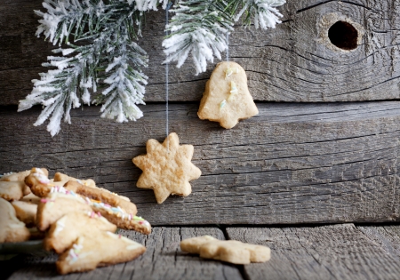 Christmas homemade cookies on wooden boards with fir backgroundの写真素材