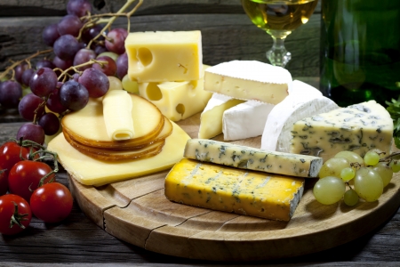 Cheese and wine various assortment vintage still life in night の写真素材