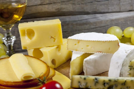 Cheese and wine various assortment on wooden boards の写真素材