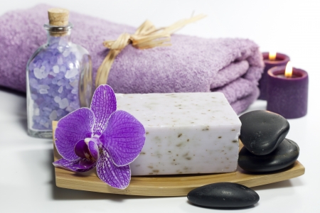 Spa soap with towel and orchids on white backgroundの写真素材