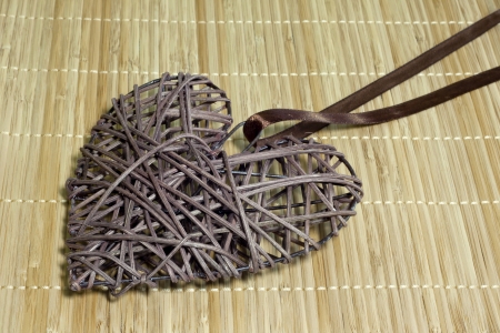 Wicker heart on bamboo mat valentines concept の写真素材