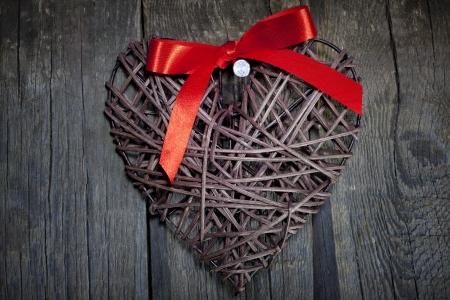 Wicker heart on wooden boards valentines conceptの写真素材