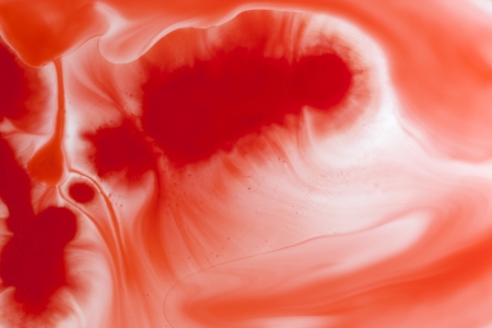 Abstract watercolor red background in water on whiteの写真素材