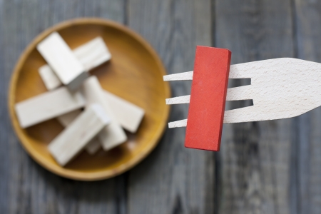 Unhealthy junk food creative concept comparison to wooden blocksの写真素材
