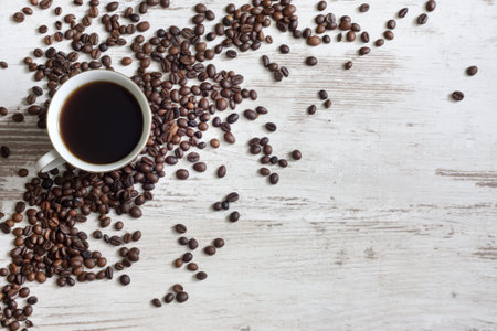 Cup of coffee with beans on retro vintage white planks concept の写真素材