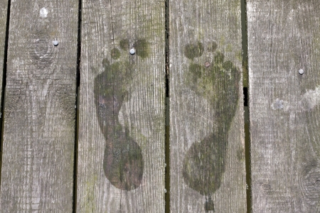 Footprints on pier on wooden boards holiday background signの写真素材
