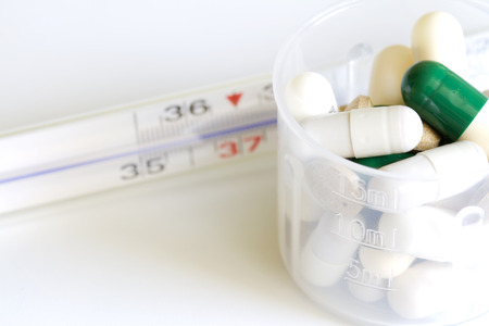Thermometer and pills pharmaceuticals conceptの写真素材