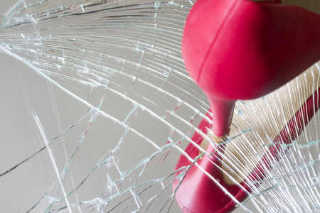 Angry and bad woman concept with shoe and broken mirrorの写真素材