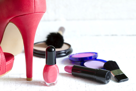 High red heels and set of cosmetics abstract on white planksの写真素材