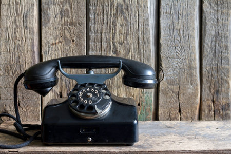 Old retro telephone on vintage boardsの写真素材