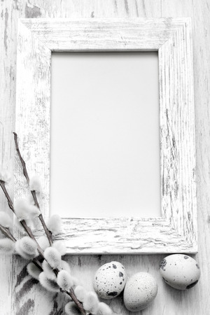Easter eggs and empty vintage photo frame backgroundの写真素材