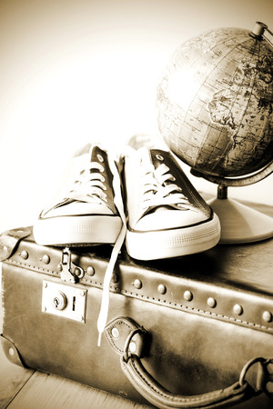 Old retro holiday suitcase and shoes for globetrotterの写真素材