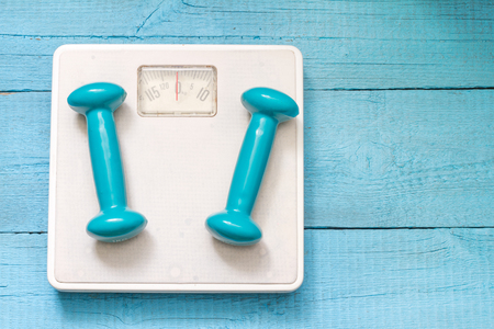 Fitness and diet abstract concept with dumbbellsの写真素材