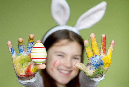 Smiling little girl with colored easter eggs