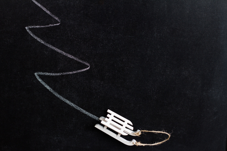 Abstract christmas background on blackboard with tree and sledの写真素材