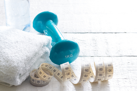 Measuring tape and dumbbells sport and lose weight conceptの写真素材