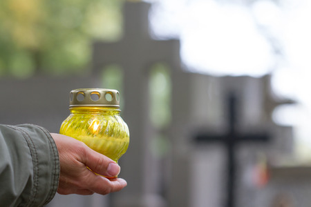 All Saints' Day and christian hands with candleの写真素材