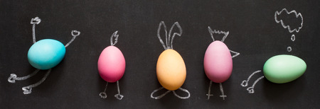 Easter funny painting eggs on blackboard abstract children's backgroundの写真素材