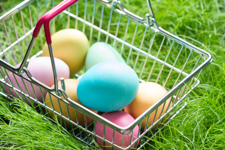 Easter eggs in a basket basket on the grass