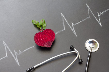 Healthy beetroot with heart shape and electrocardiogram on blackboard