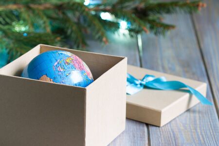 Globe in gift box. Travel gift for Christmas conceptの写真素材