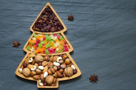 Christmas tree with nuts and dried fruits on darkの写真素材
