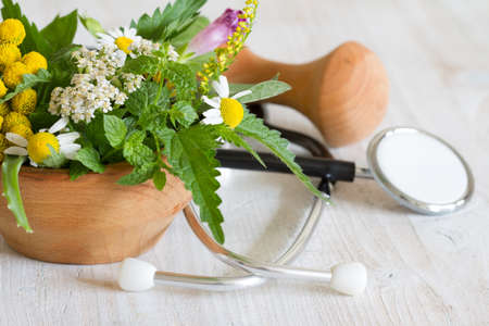 Fresh herbs and stethoscope alternative medicine conceptの写真素材