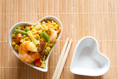 Asian dish in heart-shaped bowl, love asian food menu conceptの写真素材