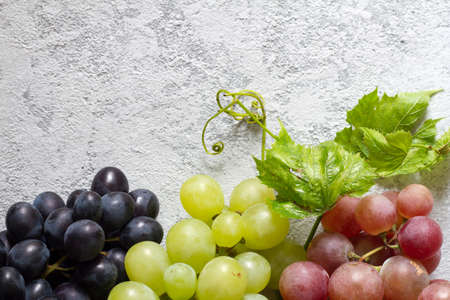 Mix of fresh ripe grapes on light backgroundの写真素材