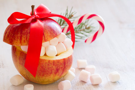 Christmas apple with marshmallows and candy cane, sweet christmas conceptの写真素材