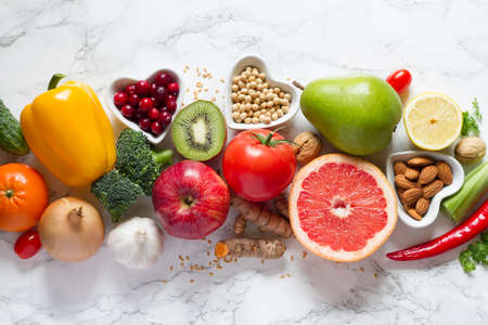 Healthy food selection: fruits, vegetables, seeds, nuts on light backgroundの写真素材