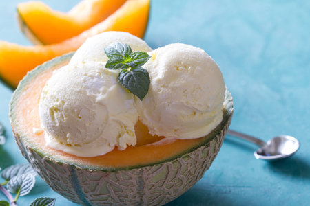 Delicious ice cream with mint leaf in melon bowlの写真素材