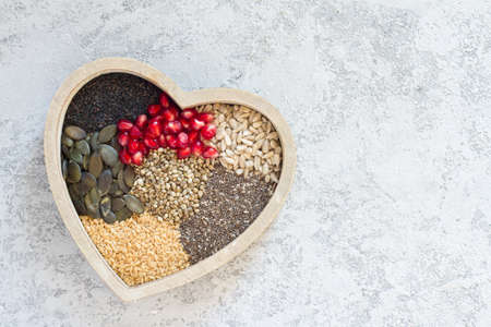 Various healthy seeds in heart, healthy diet conceptの写真素材