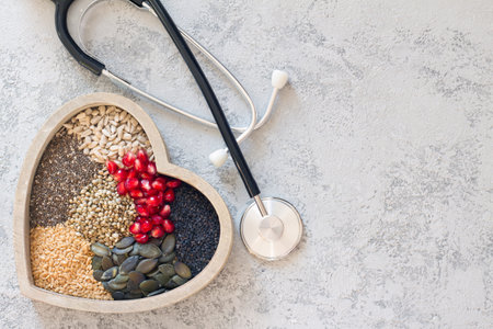 Various healthy seeds in heart with stethoscope, healthy diet conceptの写真素材