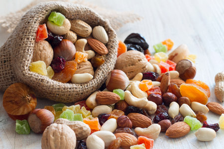 Mix of nuts and dried fruits on light backgroundの写真素材