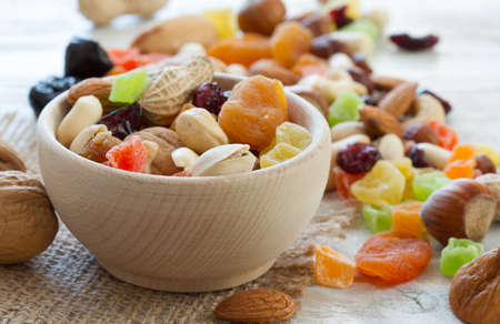 Mix of nuts and dried fruits in wooden bowlの写真素材
