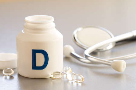 Vitamin D in capsules with stethoscope, health and immunity conceptの写真素材