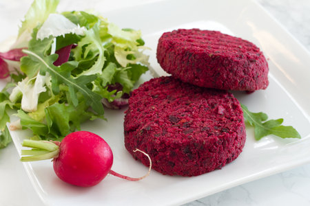 Vegetarian beetroot burgers with fresh mixed saladの写真素材