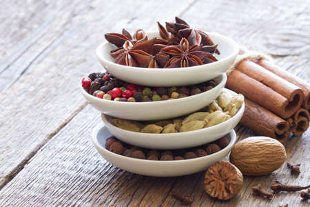 Aromatic spices in bowls on wooden boards backgroundの写真素材