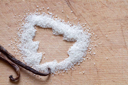 Christmas background with vanilla sugar and vanilla podの写真素材