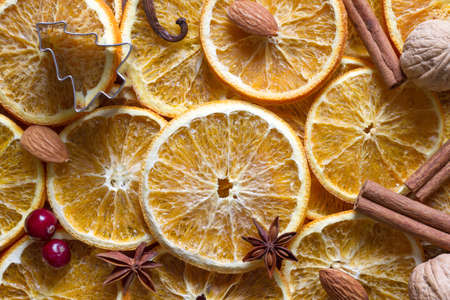 Christmas background of dried oranges, anise, cinnamon and nutsの写真素材