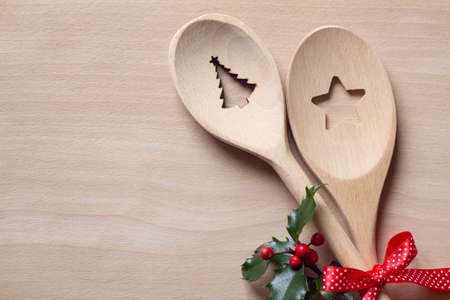 Christmas wooden spoons with holly, christmas food background conceptの写真素材