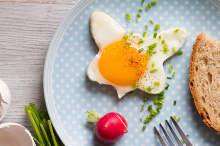 Fried egg with chives and radish, healthy spring breakfast conceptの写真素材