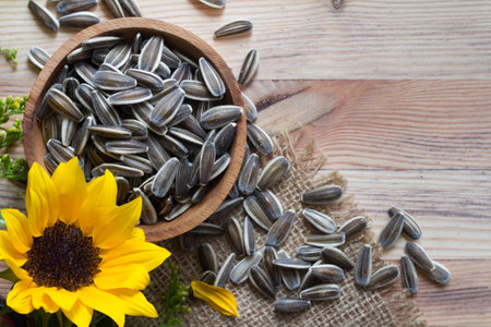 Sunflower with seeds in bowl on wooden background, conceptの写真素材