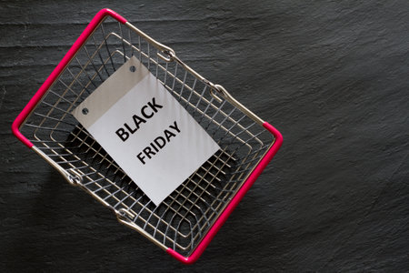 Shopping basket with sheet of calendar, black friday sale and discount conceptの写真素材
