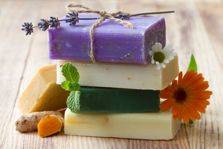 Stack of natural soaps with medicinal plants, flowers and turmericの写真素材