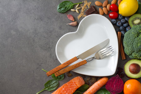 Assorted natural products for healthy heart, food background with plate and cutlery, healthy lifestyle conceptの写真素材